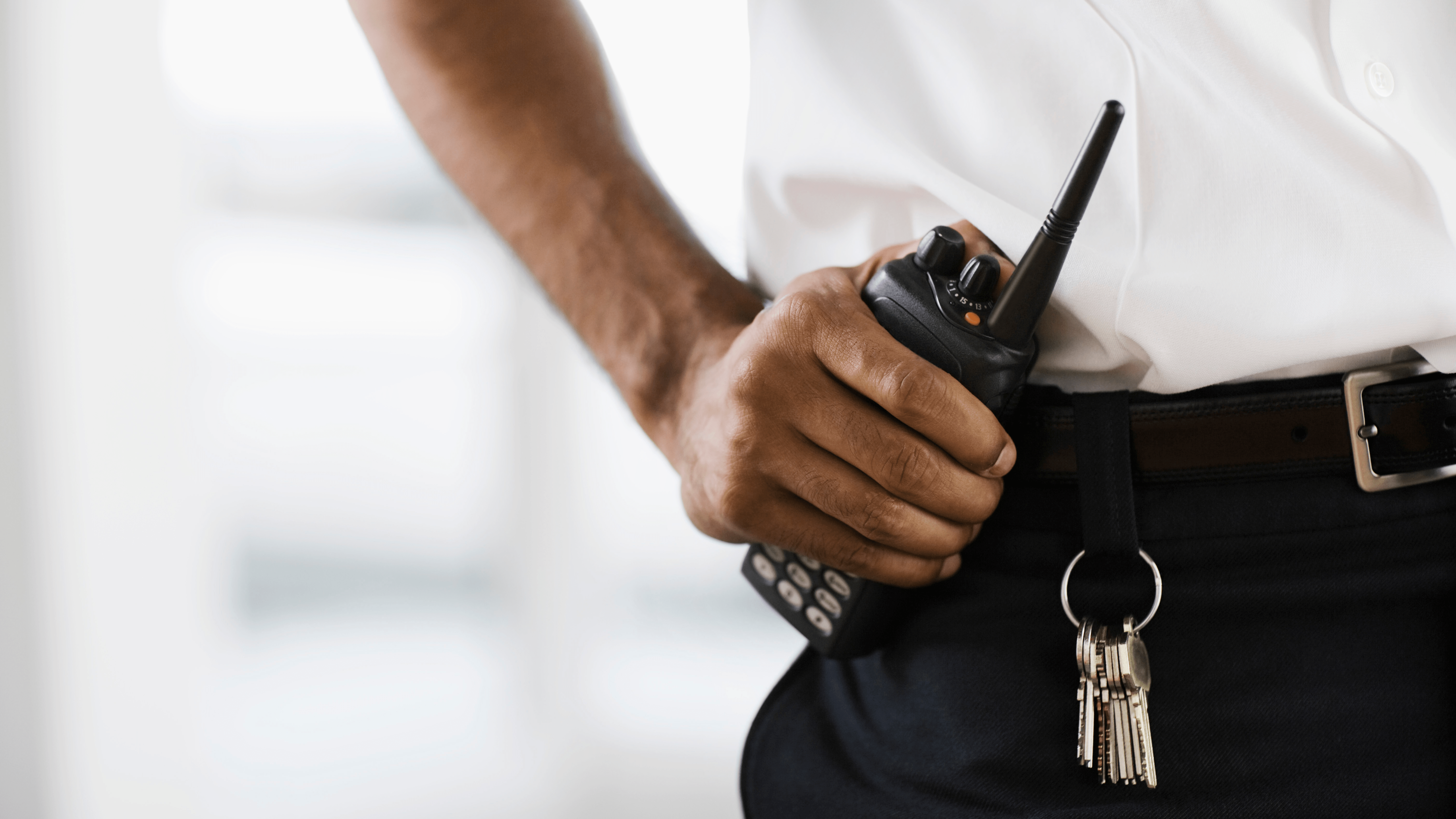 A security guard holding a radio