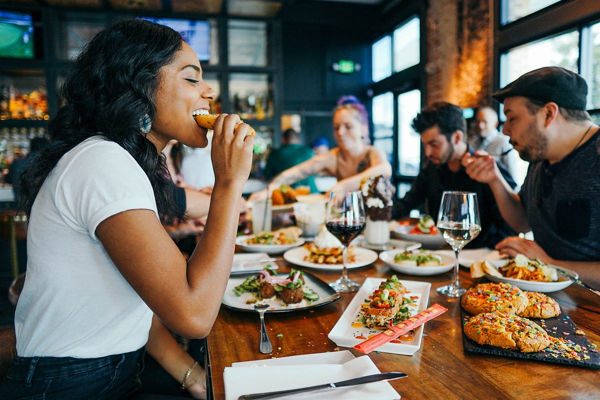 An image of a group of friends at a restaurant in the UK