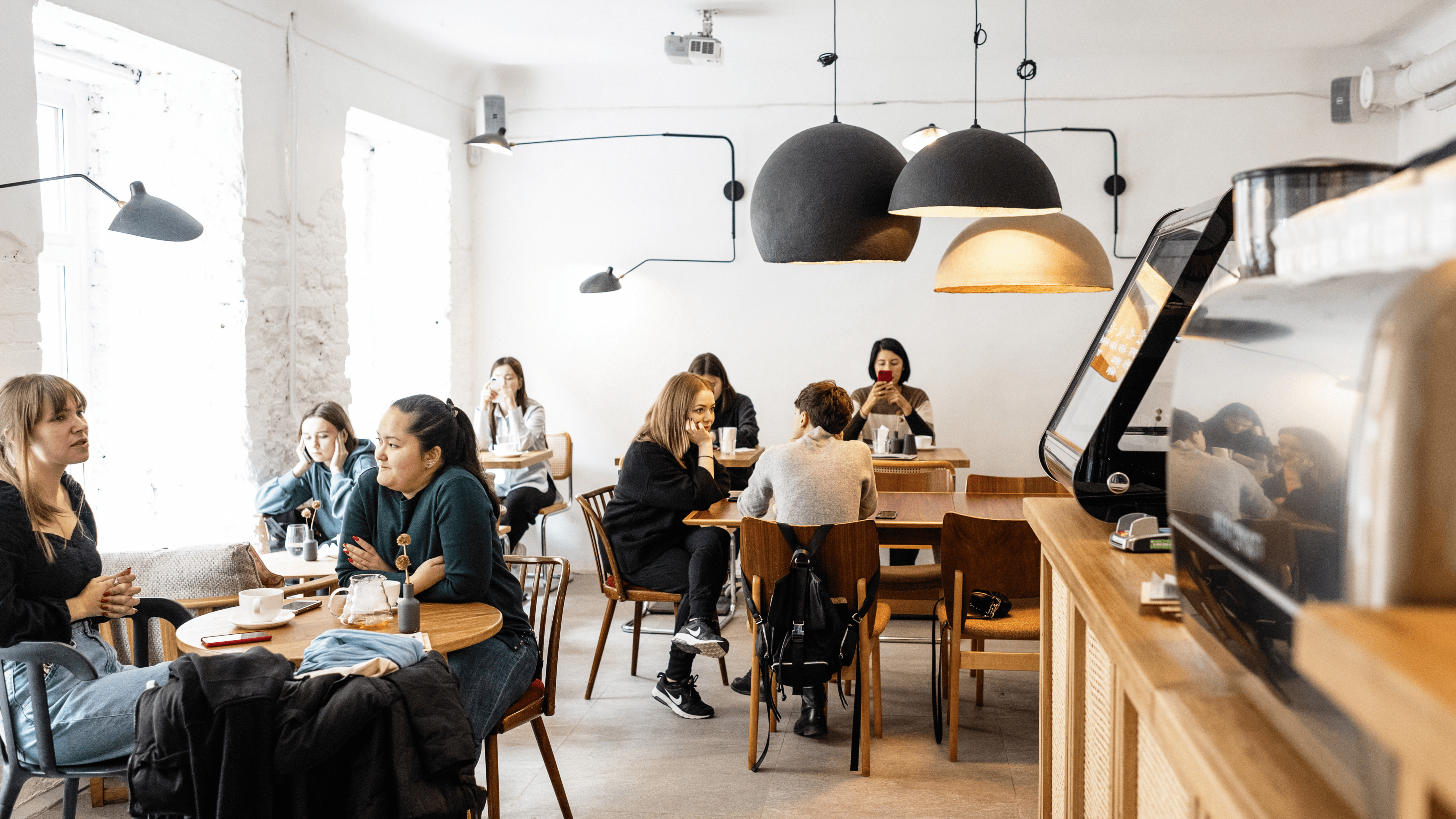 A group of people networking in a cafe close to their serviced apartment